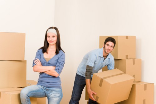 Professional movers packing household boxes for a local move